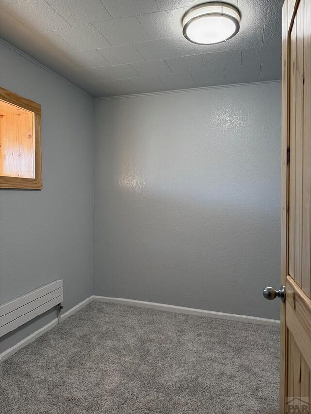 carpeted spare room with baseboards