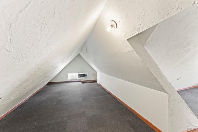 616 E 5th St, Pueblo, CO 81001 - bonus room featuring carpet floors, a textured ceiling, vaulted ceiling, and visible vents