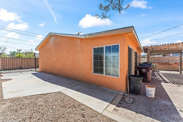 616 E 5th St, Pueblo, CO 81001 - view of home's exterior featuring a patio, stucco siding, and fence