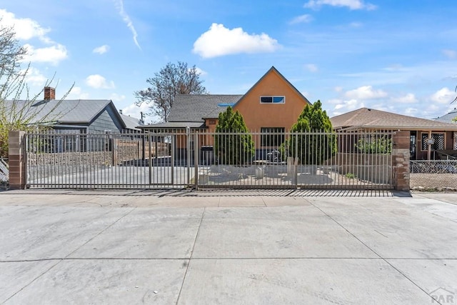 616 E 5th St, Pueblo, CO 81001 - view of front of house featuring a fenced front yard, a gate, and stucco siding