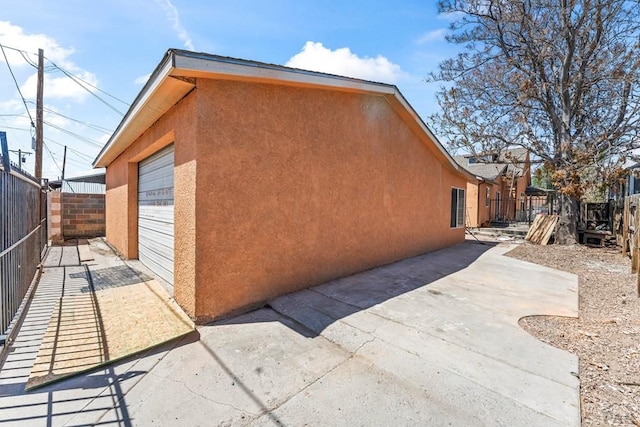 616 E 5th St, Pueblo, CO 81001 - view of side of property featuring fence, stucco siding, and a patio area