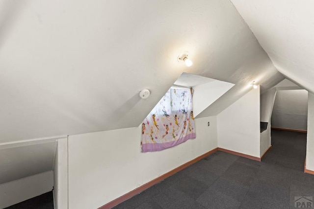 616 E 5th St, Pueblo, CO 81001 - bonus room with baseboards, vaulted ceiling, and dark colored carpet