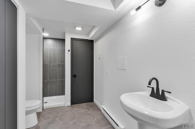 bathroom featuring a stall shower, baseboards, toilet, tile patterned flooring, and a baseboard heating unit