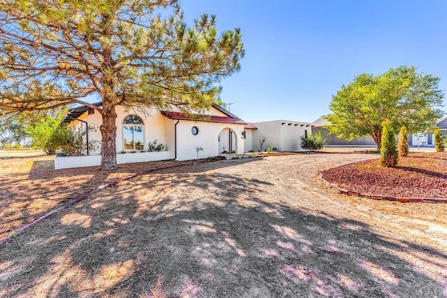 mediterranean / spanish-style home with stucco siding