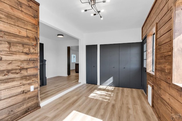 unfurnished bedroom with light wood finished floors and a closet