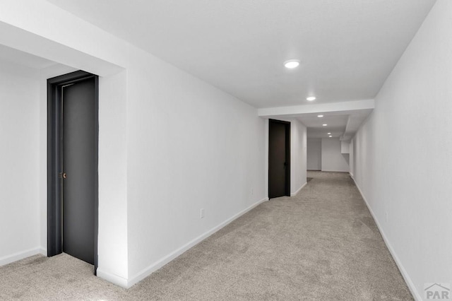 hall featuring light carpet, recessed lighting, and baseboards