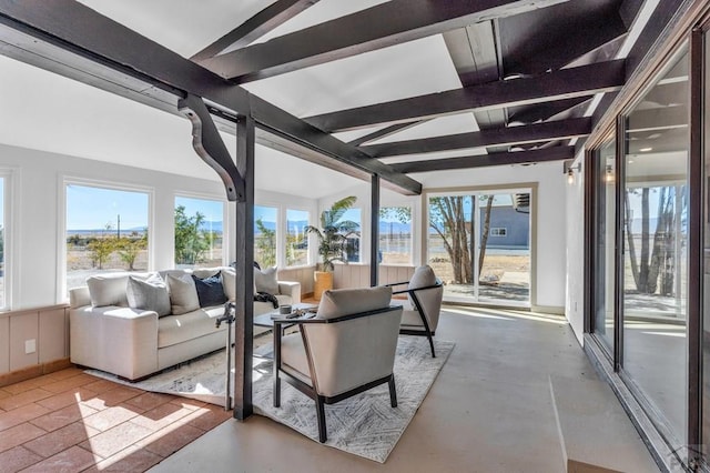 sunroom featuring vaulted ceiling with beams