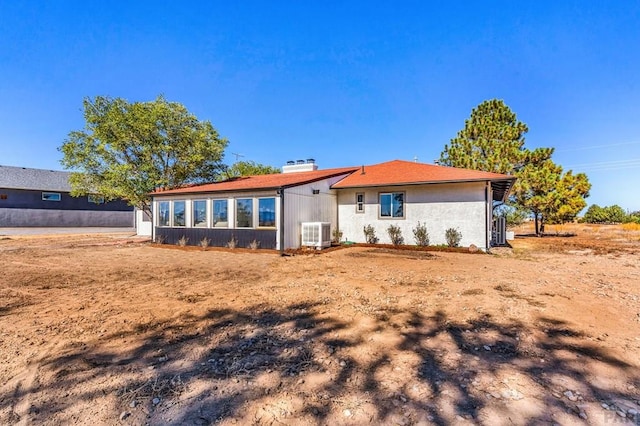 rear view of property with central air condition unit