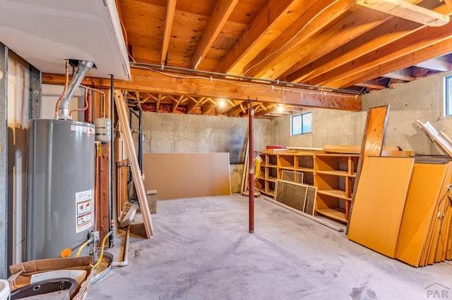 basement with plenty of natural light and gas water heater