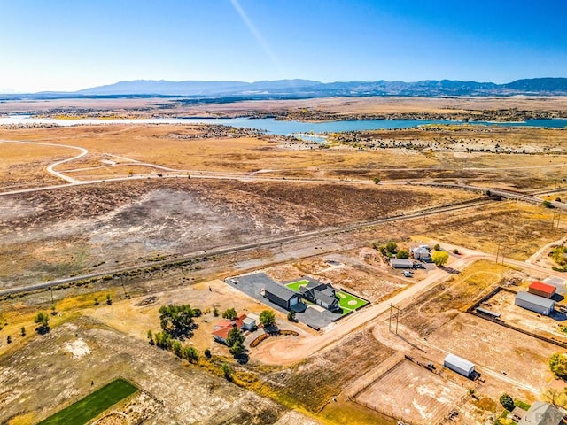 aerial view featuring a water and mountain view and a rural view