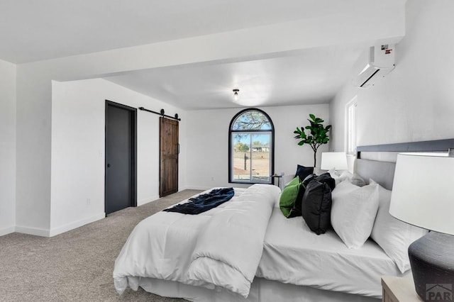 bedroom featuring light carpet, an AC wall unit, a barn door, and baseboards