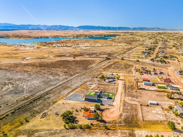 drone / aerial view with a water and mountain view