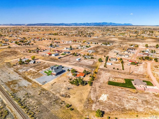 bird's eye view featuring a mountain view and view of desert