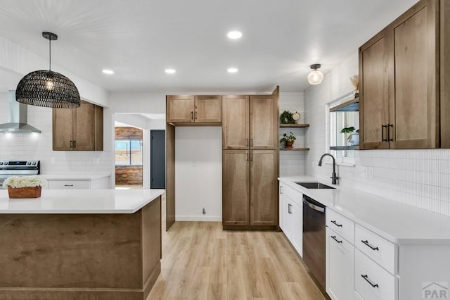 kitchen featuring white cabinets, light countertops, a sink, and dishwashing machine