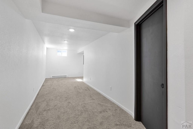 interior space with carpet floors, baseboards, and baseboard heating