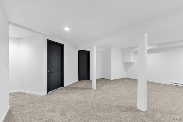 finished basement featuring recessed lighting, light colored carpet, and baseboards