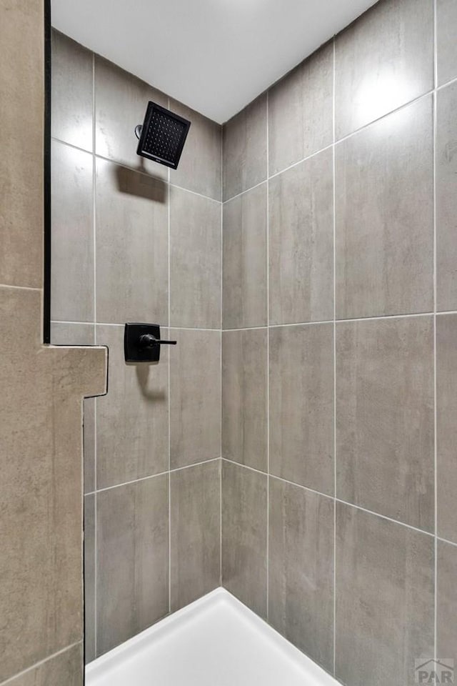 bathroom with a tile shower