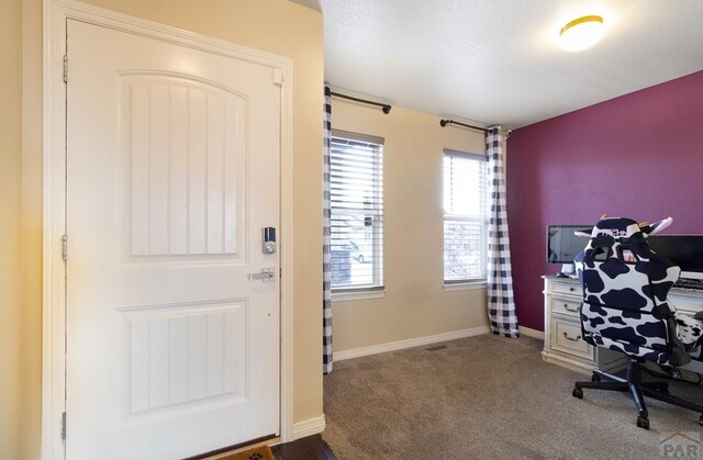 interior space featuring light carpet and baseboards