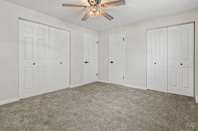 unfurnished bedroom featuring baseboards, carpet, and multiple closets