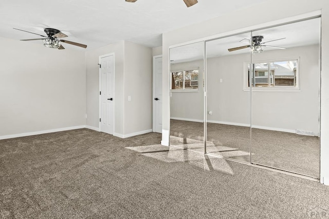 interior space featuring two closets, ceiling fan, baseboards, and carpet flooring