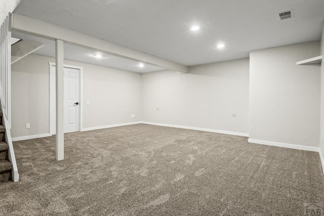 finished basement featuring baseboards, visible vents, stairs, carpet floors, and recessed lighting