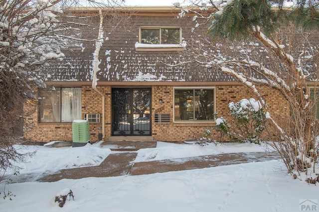 view of front of property with brick siding and cooling unit