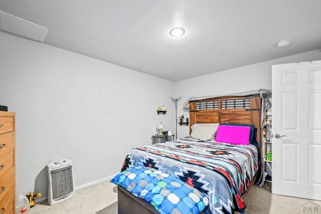 bedroom with light colored carpet and baseboards