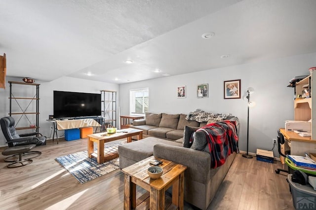 living area with light wood-type flooring and recessed lighting