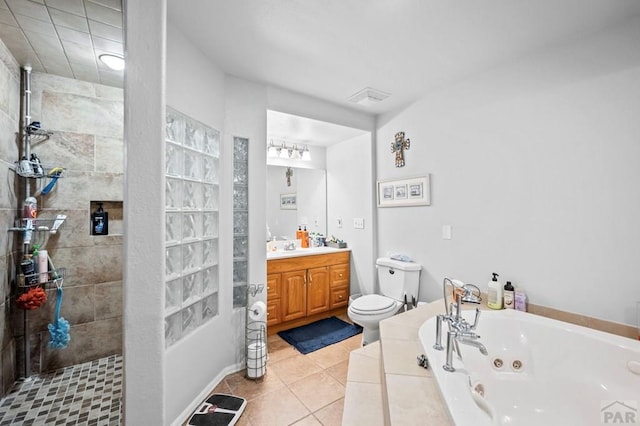 bathroom with toilet, vanity, tile patterned flooring, a jetted tub, and walk in shower