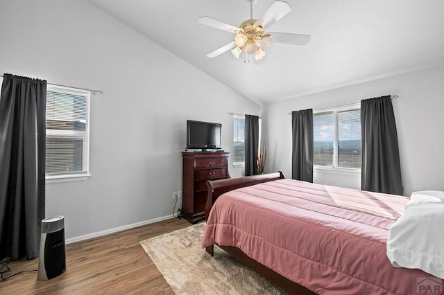 bedroom featuring lofted ceiling, ceiling fan, baseboards, and wood finished floors