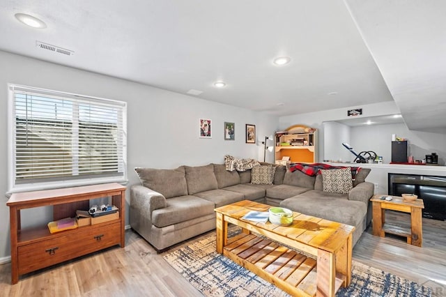 living area featuring recessed lighting, visible vents, and light wood-style flooring