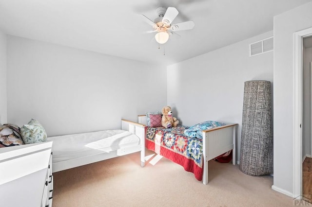 carpeted bedroom with visible vents and ceiling fan