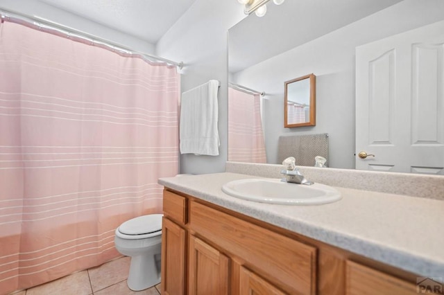 bathroom with toilet, tile patterned flooring, and vanity