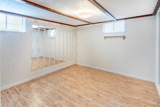 1329 Alexander Cir, Pueblo, CO 81001 - below grade area with plenty of natural light, wood finished floors, and a textured wall