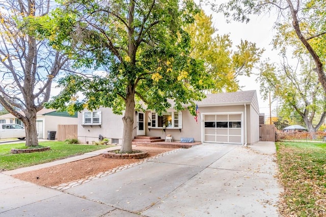 1329 Alexander Cir, Pueblo, CO 81001 - view of front facade with a garage, concrete driveway, and stucco siding