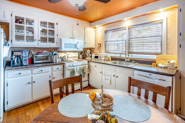 1329 Alexander Cir, Pueblo, CO 81001 - kitchen with white appliances, ceiling fan, light wood finished floors, and white cabinetry