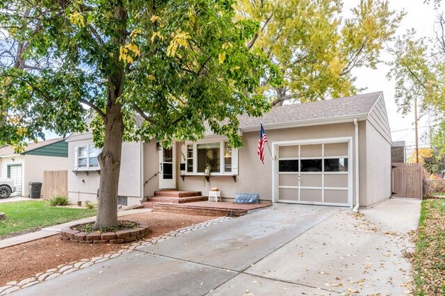 1329 Alexander Cir, Pueblo, CO 81001 - view of front facade featuring a garage, driveway, and stucco siding