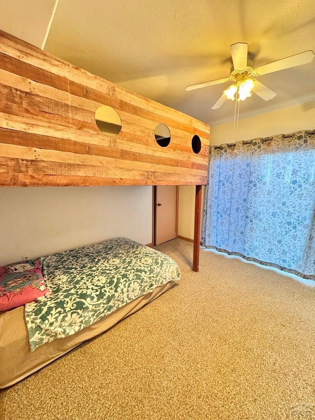 17345 US Highway 50, Las Animas, CO 81054 - bedroom with light colored carpet, wooden walls, and ceiling fan