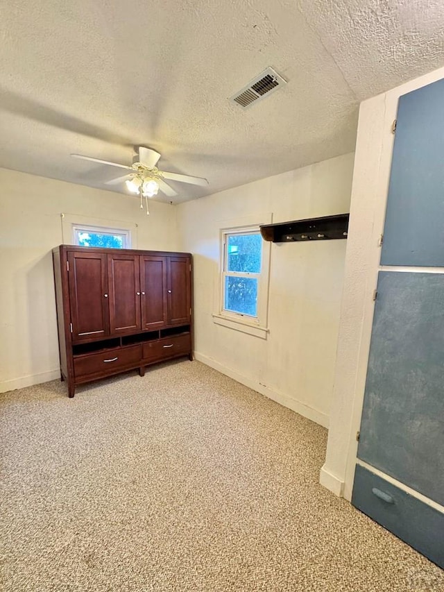 17345 US Highway 50, Las Animas, CO 81054 - bedroom featuring a textured ceiling, light colored carpet, and ceiling fan