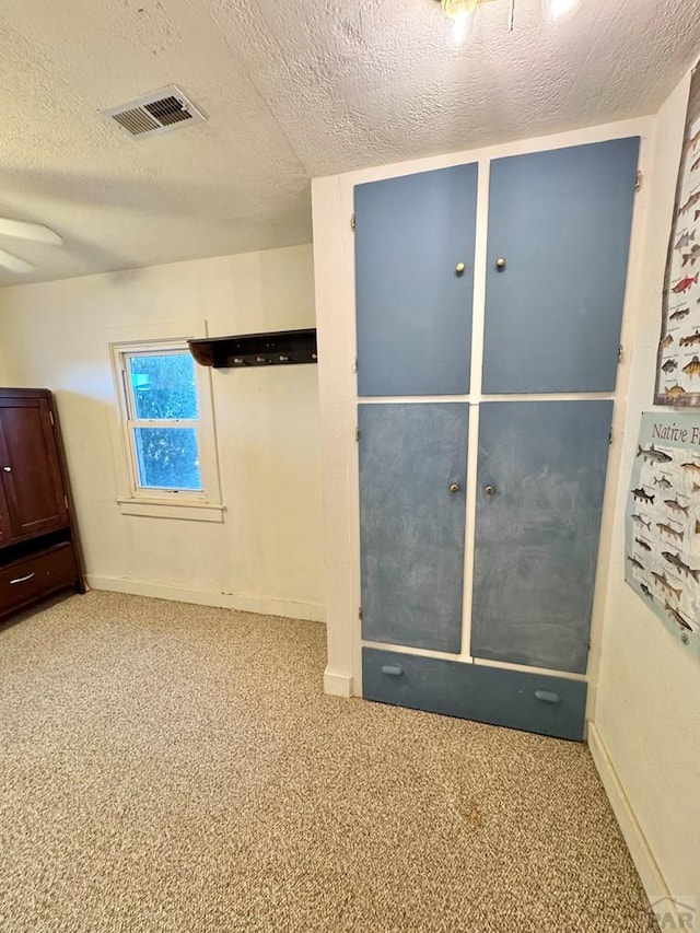 17345 US Highway 50, Las Animas, CO 81054 - unfurnished bedroom featuring carpet floors and a textured ceiling