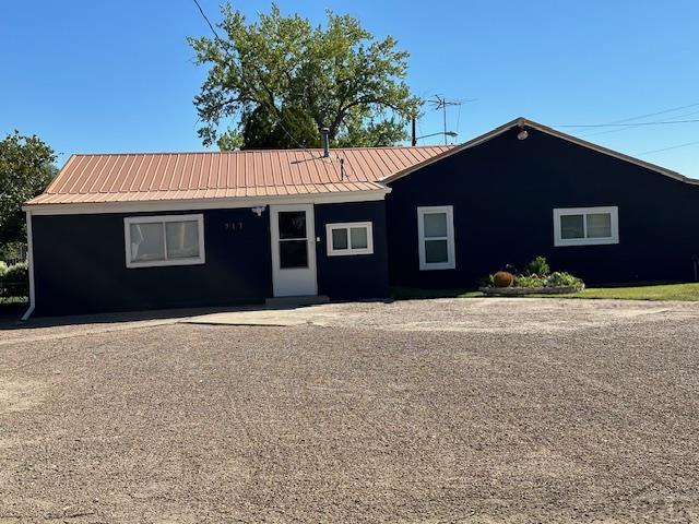 ranch-style house with metal roof