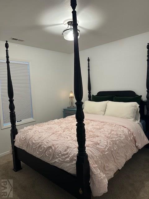 bedroom with a ceiling fan, dark colored carpet, and visible vents