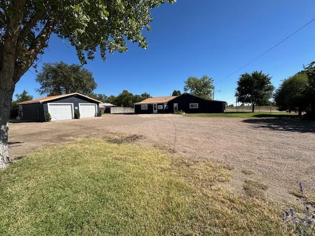 view of yard with a detached garage