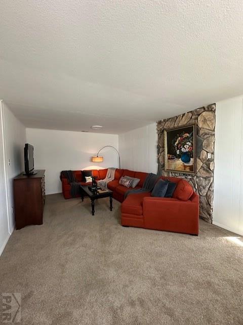 living area featuring a textured ceiling and carpet floors