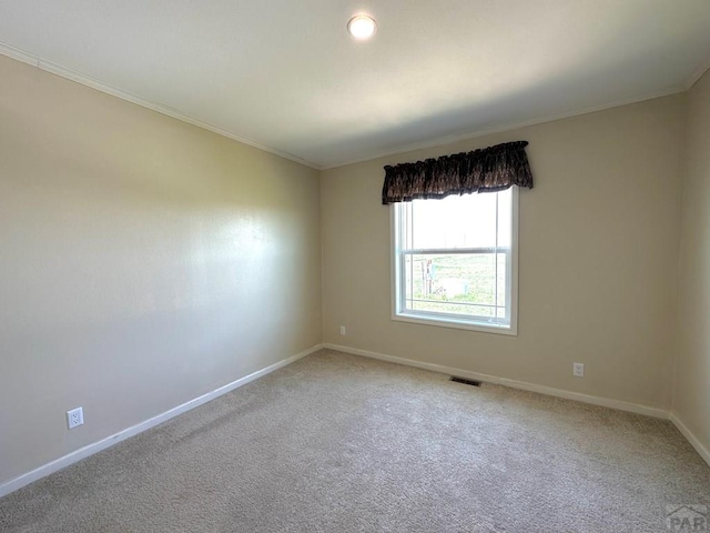 15406 County Rd E.25, Ordway, CO 81063 - spare room featuring light colored carpet and ornamental molding