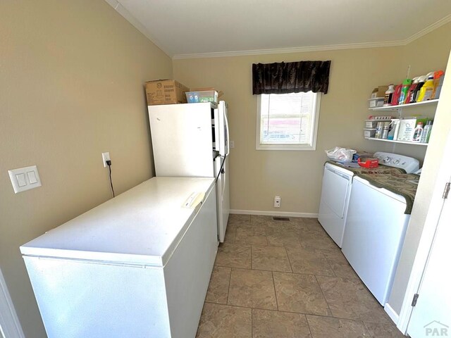 15406 County Rd E.25, Ordway, CO 81063 - laundry room with washing machine and clothes dryer, ornamental molding, and stone finish flooring