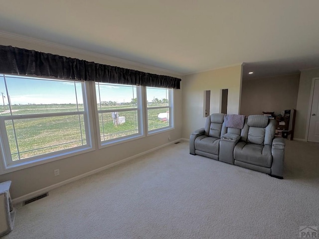 15406 County Rd E.25, Ordway, CO 81063 - carpeted living room featuring crown molding and plenty of natural light