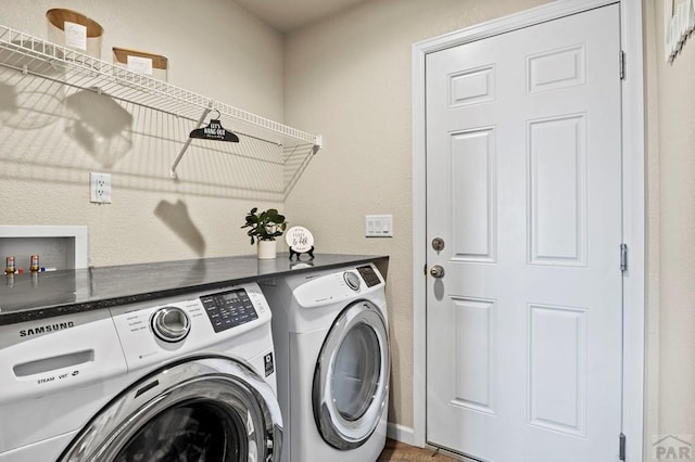 washroom featuring laundry area and separate washer and dryer