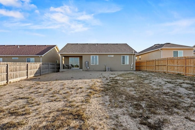 back of house with a patio area, a fenced backyard, and stucco siding