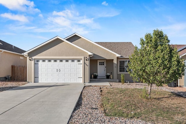 ranch-style house featuring driveway, an attached garage, fence, and stucco siding